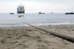 A cable landing in progress at a sea shore